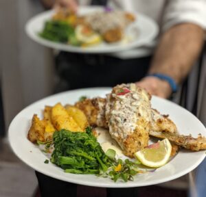 A beautifully packaged takeout order from Pepe & Sale, representing fine dining at home.