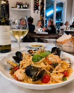 A beautiful plate of fresh Italian seafood pasta with white wine at Pepe and Sale in Stuart FL